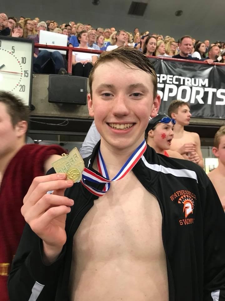 swimmer holding a medal